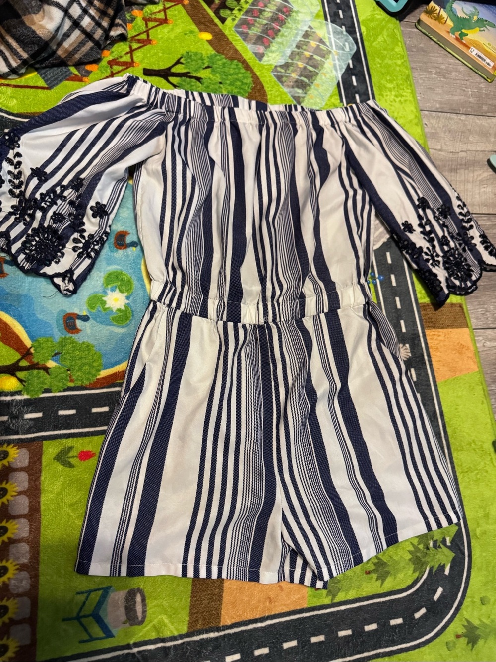 Style house blue and white striped romper with blue floral design on the sleeves